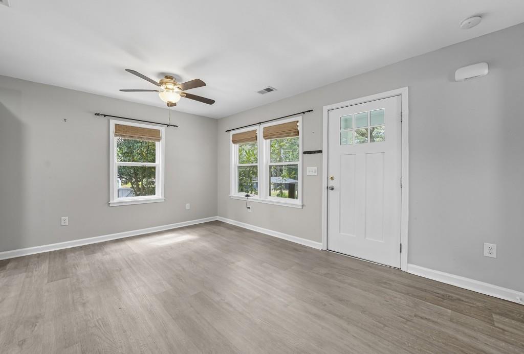 2490 Barge Road Southwest Atlanta, GA 30331 - Photo 3 of 27 a view of an empty room with a window and wooden floor