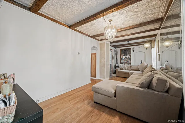 a living room with furniture and a chandelier