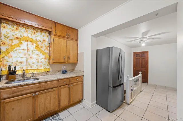 a kitchen with a refrigerator a sink and cabinets