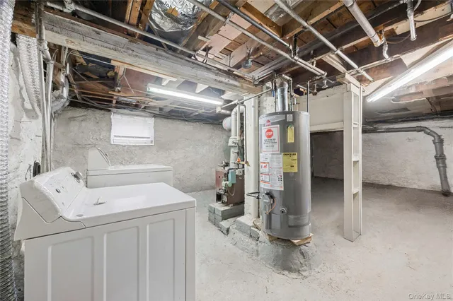 a utility room with dryer washer and stair