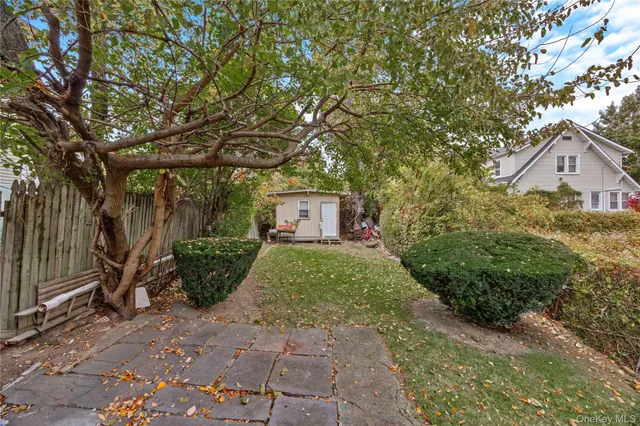 a backyard of a house with table and chairs