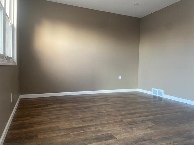 509 West Erie Street Spring Valley, IL 61362 - Photo 3 of 19 a view of an empty room with wooden floor and a window