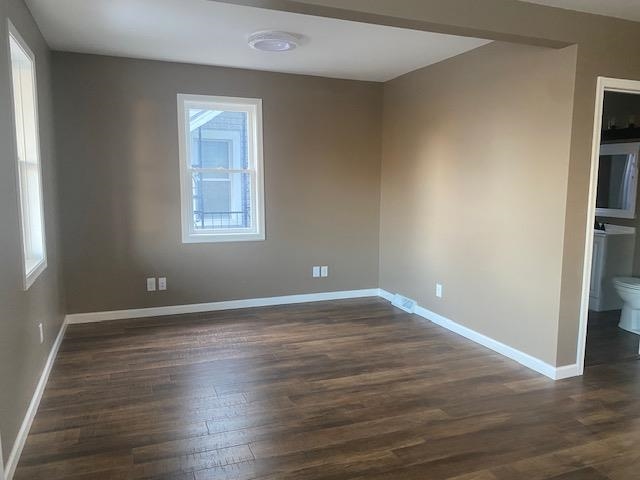 509 West Erie Street Spring Valley, IL 61362 - Photo 5 of 19 an empty room with wooden floor and windows