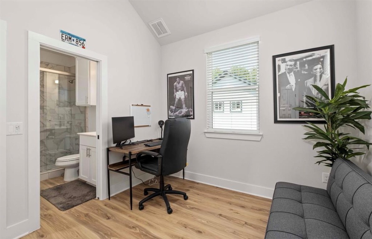7407 Bethune Avenue, Unit 2 Austin, TX 78752 - Photo 22 of 30 a view of a workspace with furniture and a window