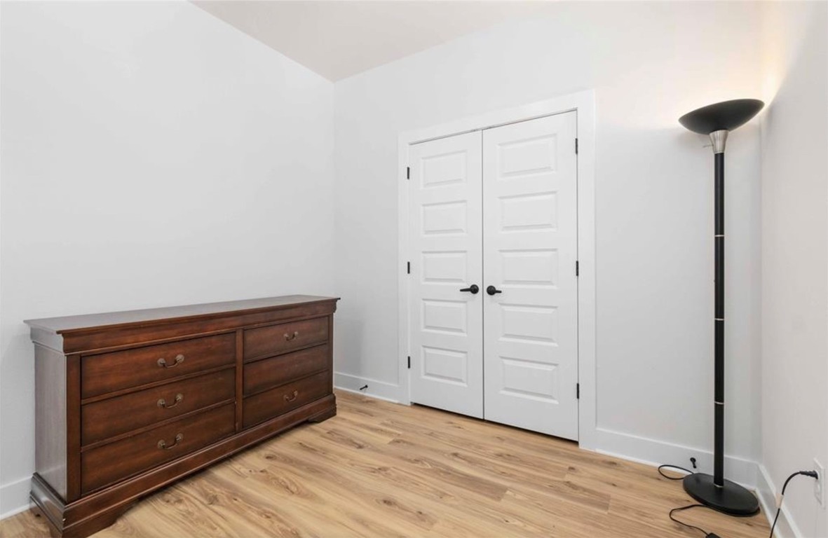 7407 Bethune Avenue, Unit 2 Austin, TX 78752 - Photo 25 of 30 a room with a dresser and a chair