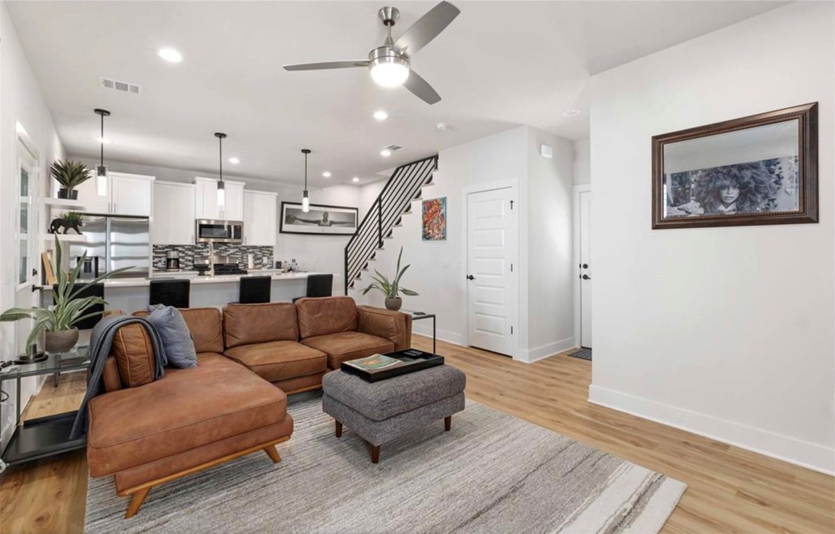 7407 Bethune Avenue, Unit 2 Austin, TX 78752 - Photo 6 of 30 a living room with furniture kitchen view and a chandelier