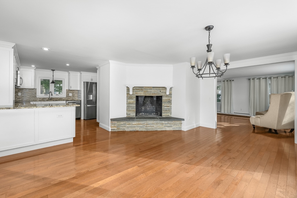 103 Pine Tree Drive Barnstable, MA 02632 - Photo 12 of 42 a view of a livingroom with a fireplace a sink and dishwasher