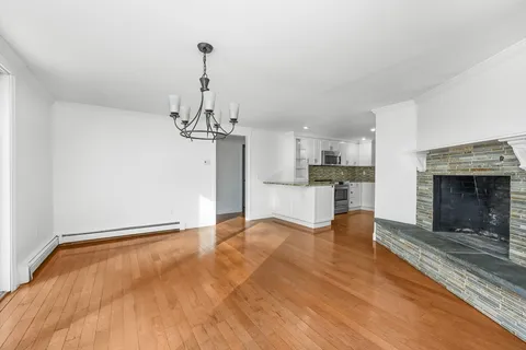 a view of a kitchen with a sink and a fireplace