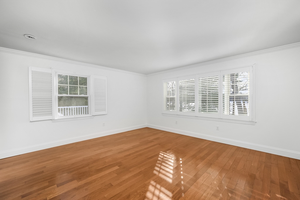 103 Pine Tree Drive Barnstable, MA 02632 - Photo 16 of 42 a view of an empty room with wooden floor and a window