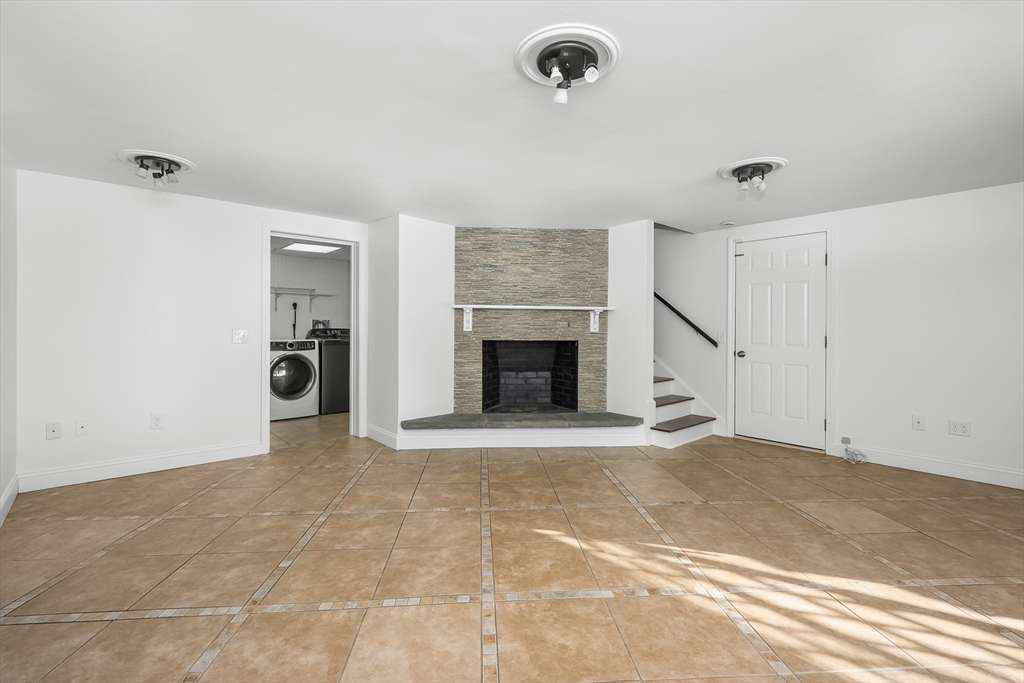 103 Pine Tree Drive Barnstable, MA 02632 - Photo 20 of 42 a view of an empty room with a fireplace and a window