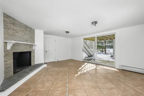 a view of a livingroom with an empty space and a fireplace