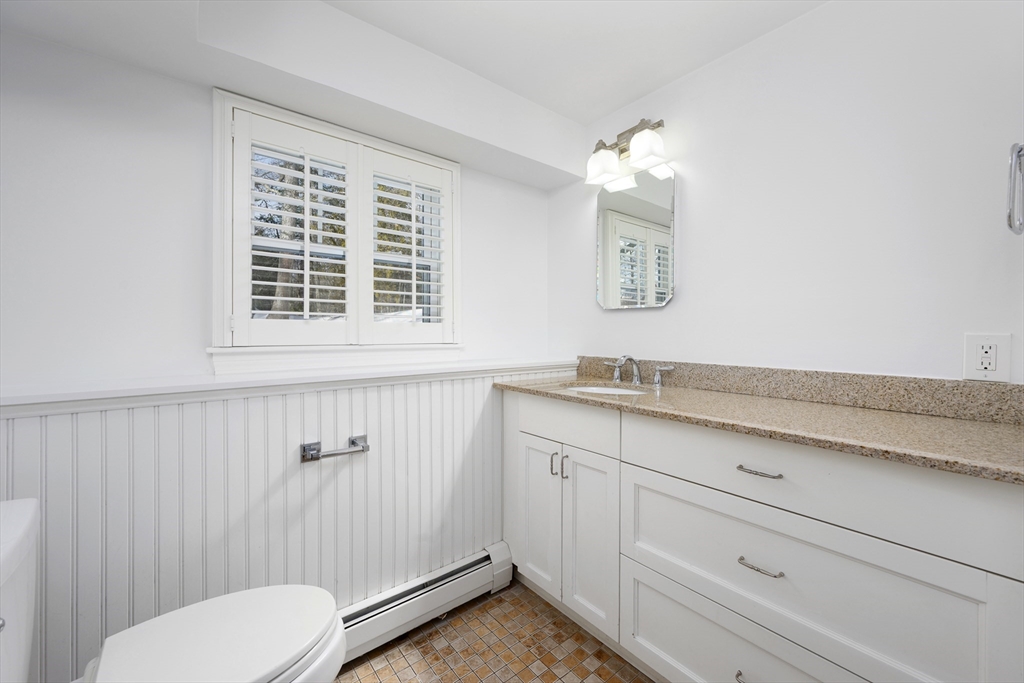 103 Pine Tree Drive Barnstable, MA 02632 - Photo 24 of 42 a bathroom with a toilet sink and mirror
