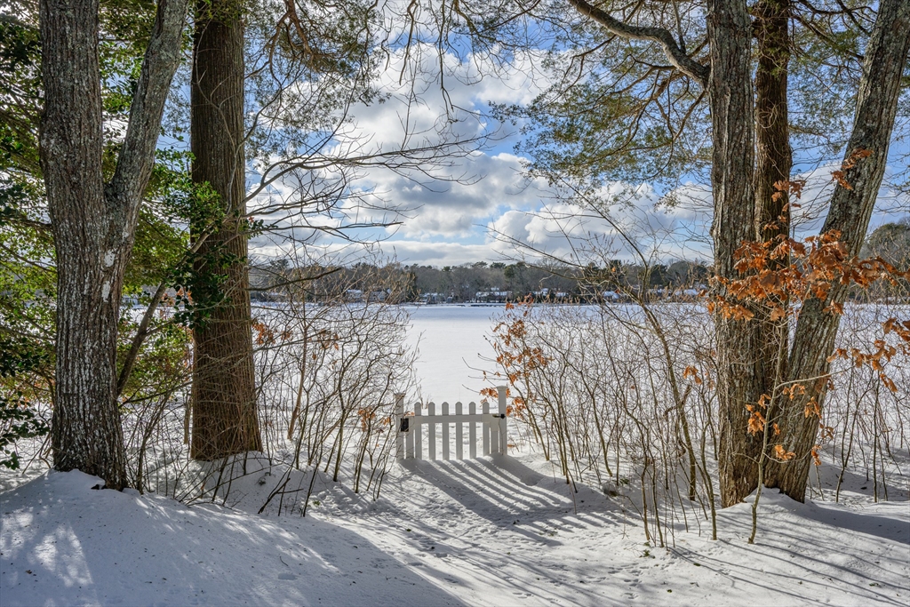 103 Pine Tree Drive Barnstable, MA 02632 - Photo 29 of 42 a view of a pathway with a wrought fence