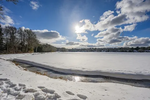 a view of a house with wooden fence