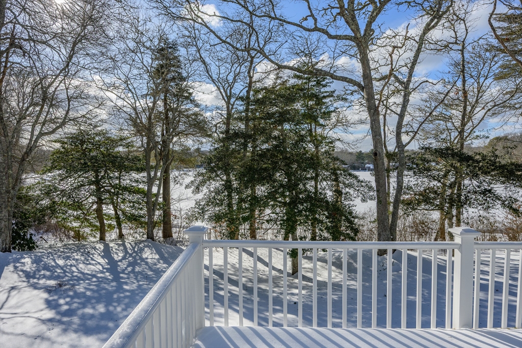 103 Pine Tree Drive Barnstable, MA 02632 - Photo 33 of 42 a view of a wooden deck and trees