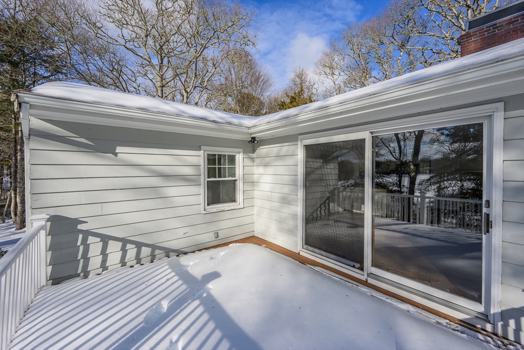 103 Pine Tree Drive Barnstable, MA 02632 - Photo 35 of 42 a view of a balcony with floor to ceiling window and wooden floor