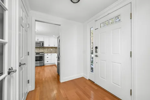 a view of a kitchen with wooden floor and a sink