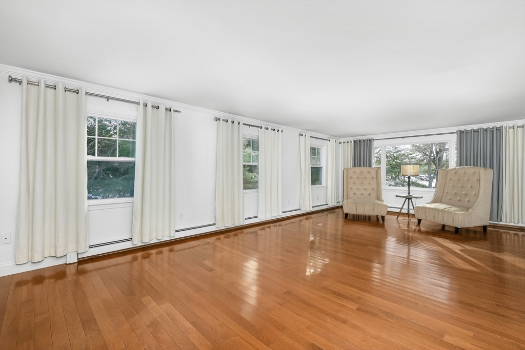 103 Pine Tree Drive Barnstable, MA 02632 - Photo 5 of 42 a view of an empty room with a window and wooden floor