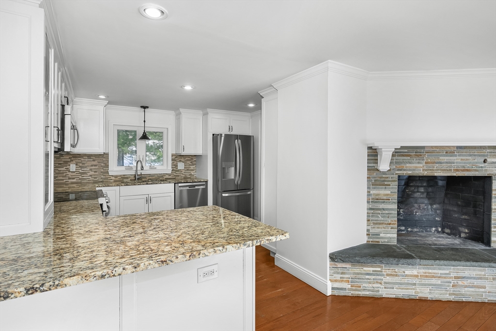 103 Pine Tree Drive Barnstable, MA 02632 - Photo 8 of 42 a kitchen with kitchen island granite countertop a refrigerator oven a sink and dishwasher