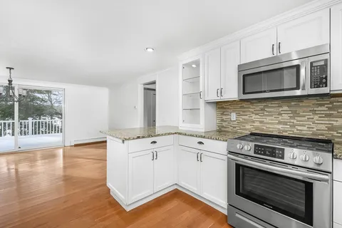 a kitchen with stainless steel appliances granite countertop a stove and a microwave
