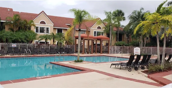 a view of a house with swimming pool and sitting area