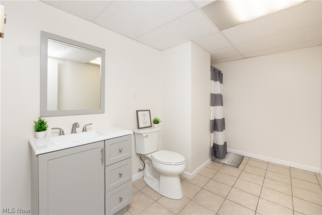12379 Portage Street Rittman, OH 44270 - Photo 37 of 44 Bathroom with a drop ceiling, large vanity, tile floors, and toilet