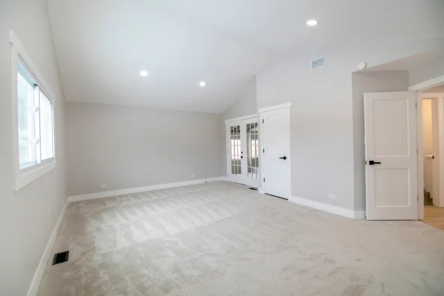 an empty room with windows and closet