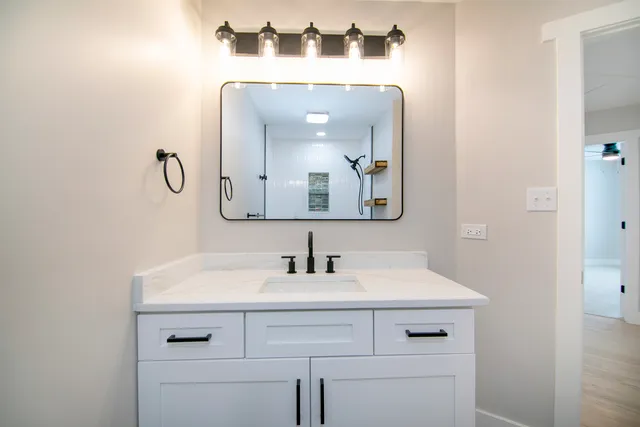 a bathroom with a sink and a mirror