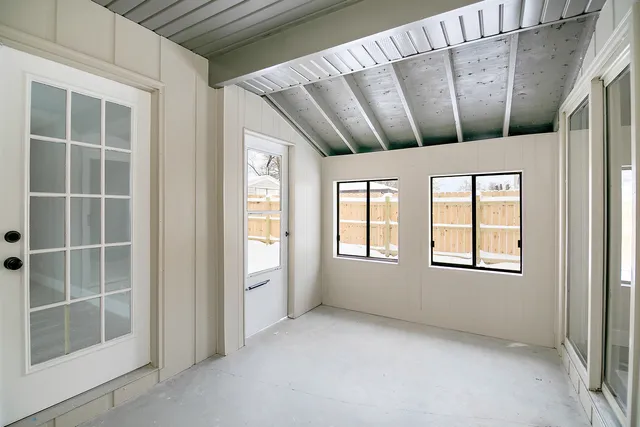 an empty room with fan and windows