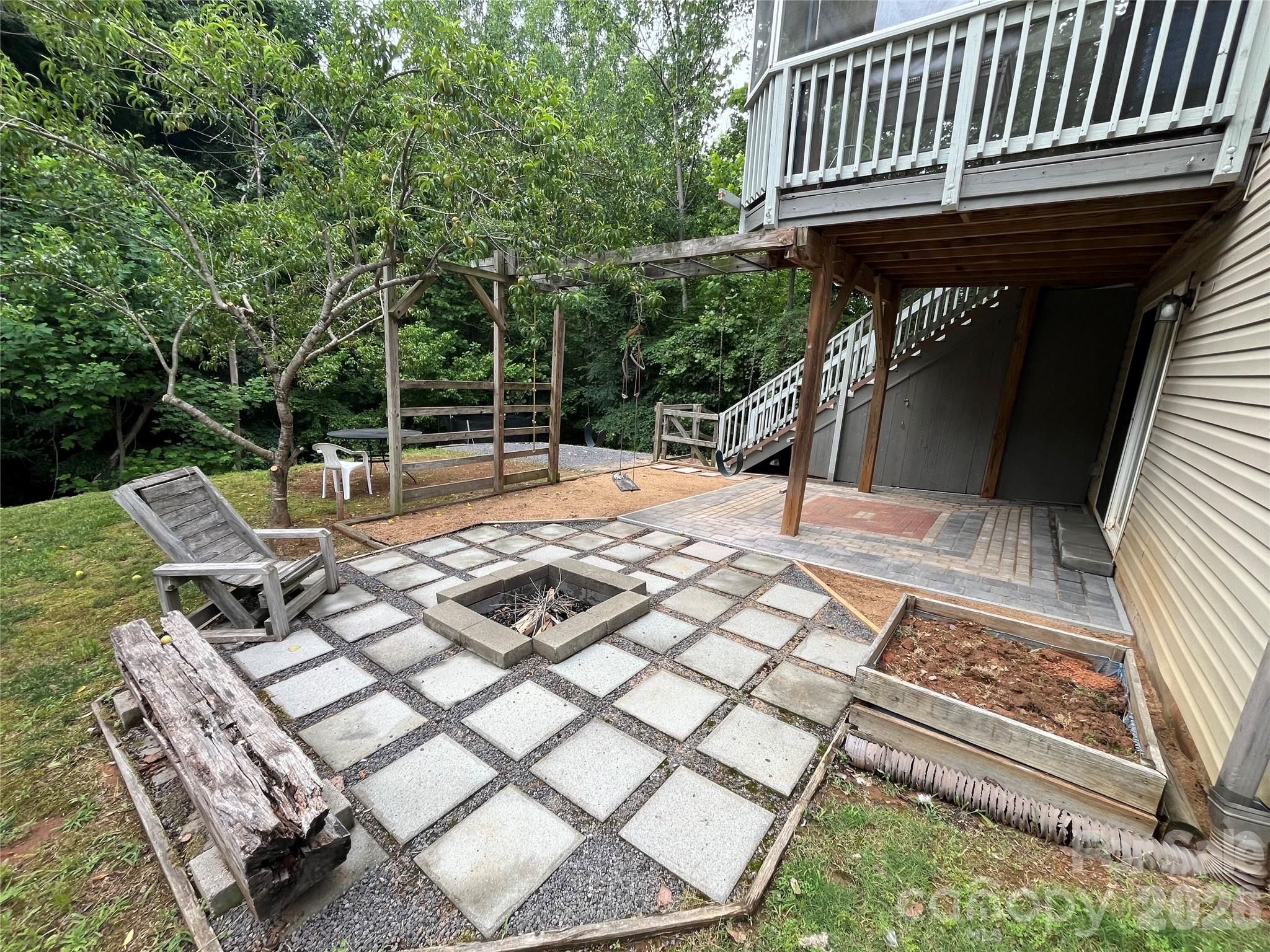 7532 West Berkeley Road, Unit 25 Denver, NC 28037 - Photo 34 of 36 a backyard of a house with barbeque oven table and chairs