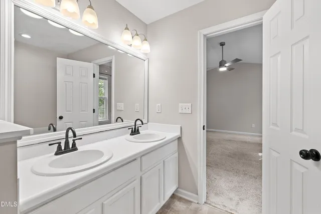 an empty room with a window and ceiling fan