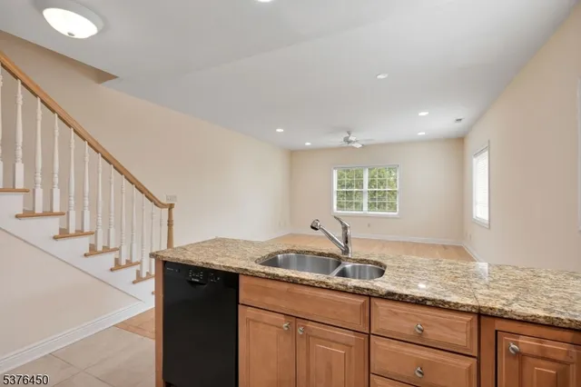 a kitchen with granite countertop a sink and a window