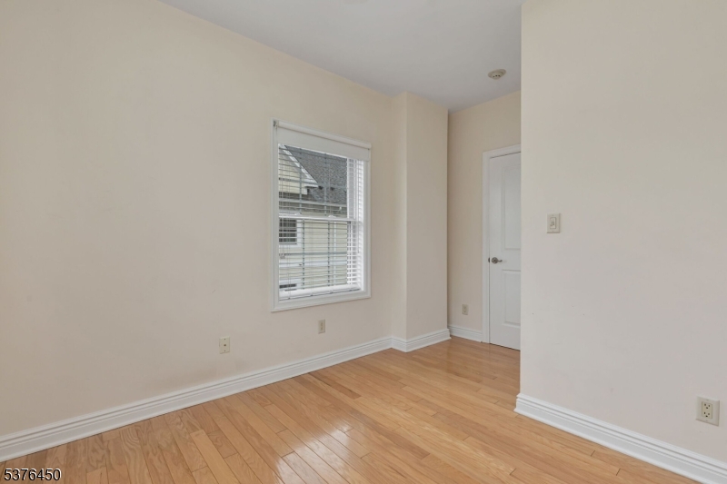 453 Springfield Avenue Berkeley Heights, NJ 07922 - Photo 20 of 34 an empty room with wooden floor and windows