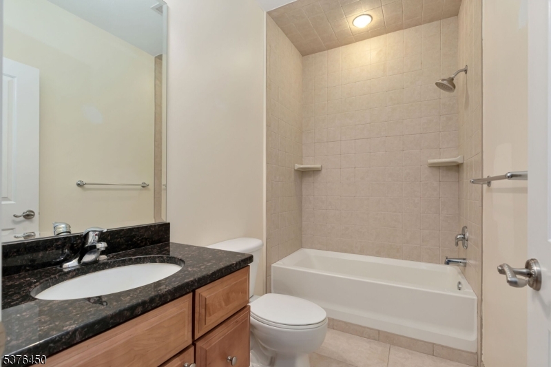 453 Springfield Avenue Berkeley Heights, NJ 07922 - Photo 23 of 34 a bathroom with a granite countertop sink toilet mirror and bathtub