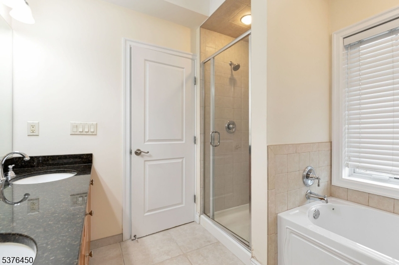 453 Springfield Avenue Berkeley Heights, NJ 07922 - Photo 27 of 34 a bathroom with a tub a sink and a shower