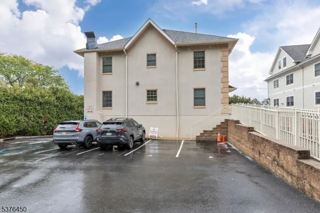 a car parked in front of a white house