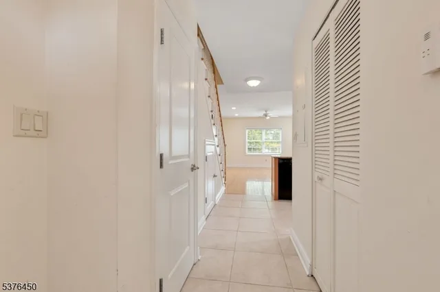 a view of a hallway with wooden shelves