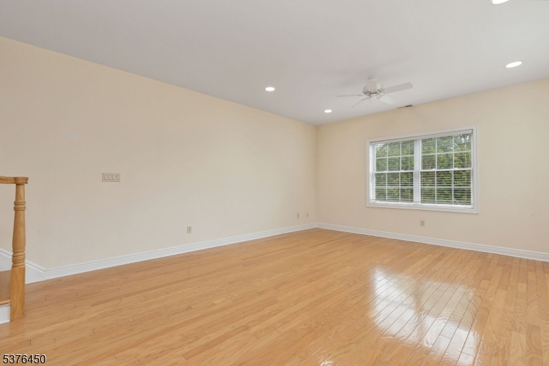 453 Springfield Avenue Berkeley Heights, NJ 07922 - Photo 8 of 34 a view of an empty room with wooden floor and a window