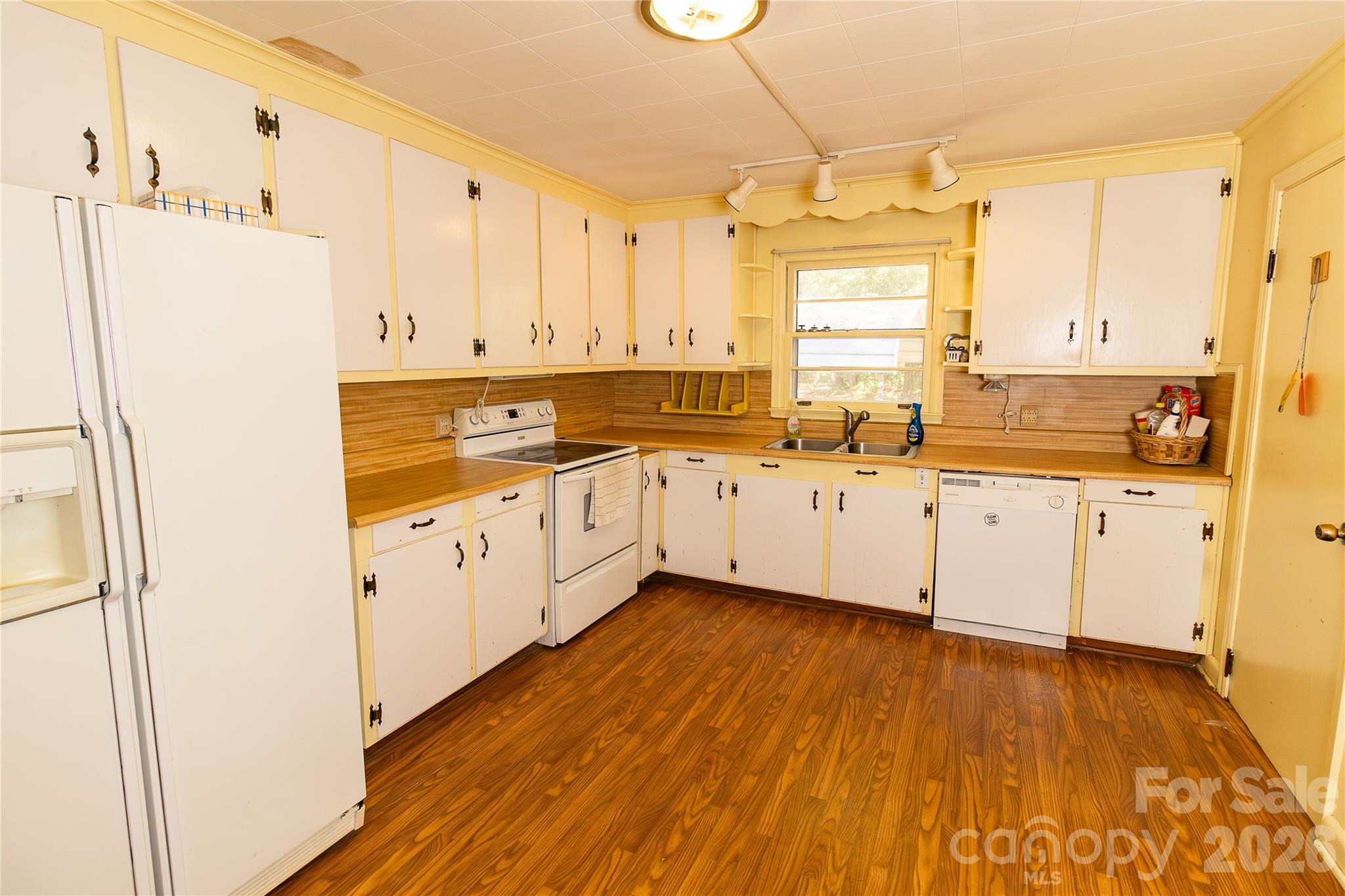 609 Wilcox Avenue Gaffney, SC 29341 - Photo 12 of 23 a kitchen with a sink a refrigerator a stove and white cabinets