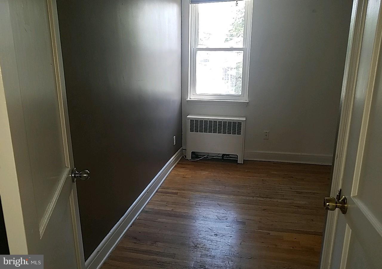 8539 Willow Oak Road Baltimore, MD 21234 - Photo 18 of 30 an empty room with wooden floor and windows