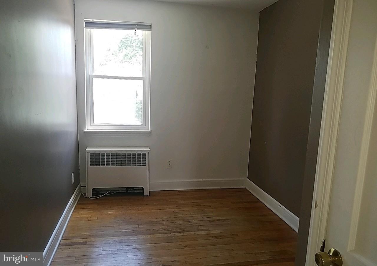 8539 Willow Oak Road Baltimore, MD 21234 - Photo 19 of 30 an empty room with wooden floor and windows