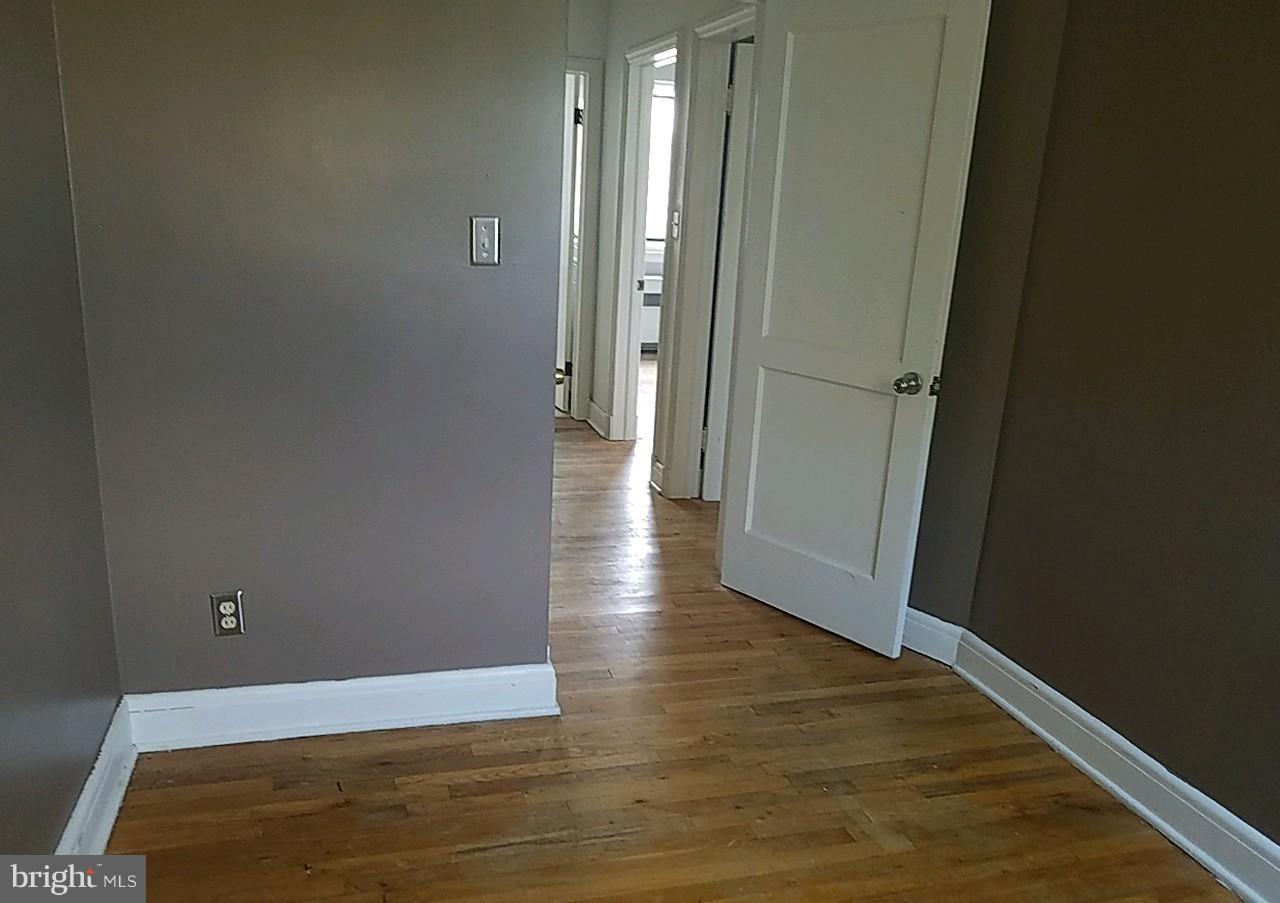 8539 Willow Oak Road Baltimore, MD 21234 - Photo 20 of 30 a view of an empty room with wooden floor