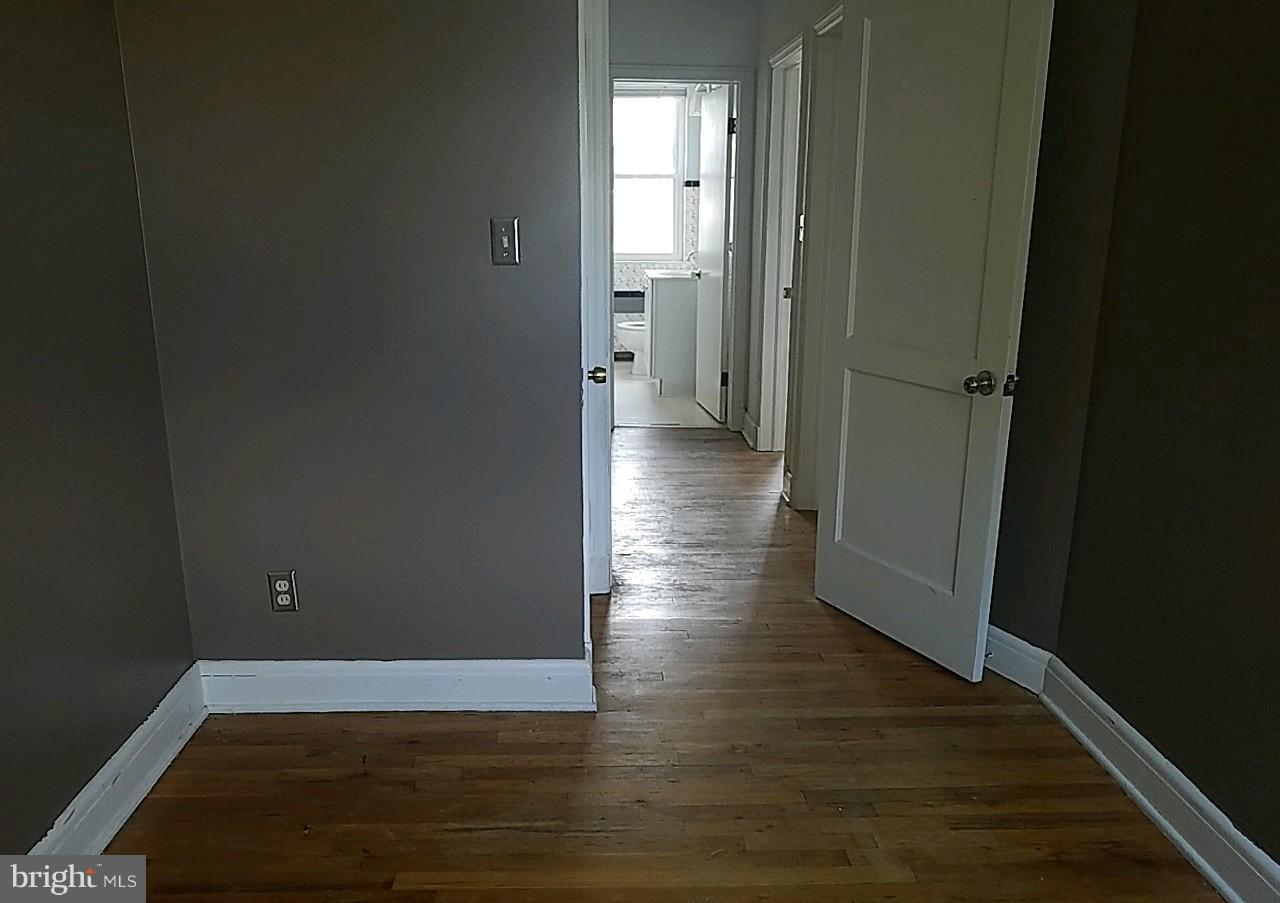 8539 Willow Oak Road Baltimore, MD 21234 - Photo 21 of 30 a view of a hallway with wooden floor