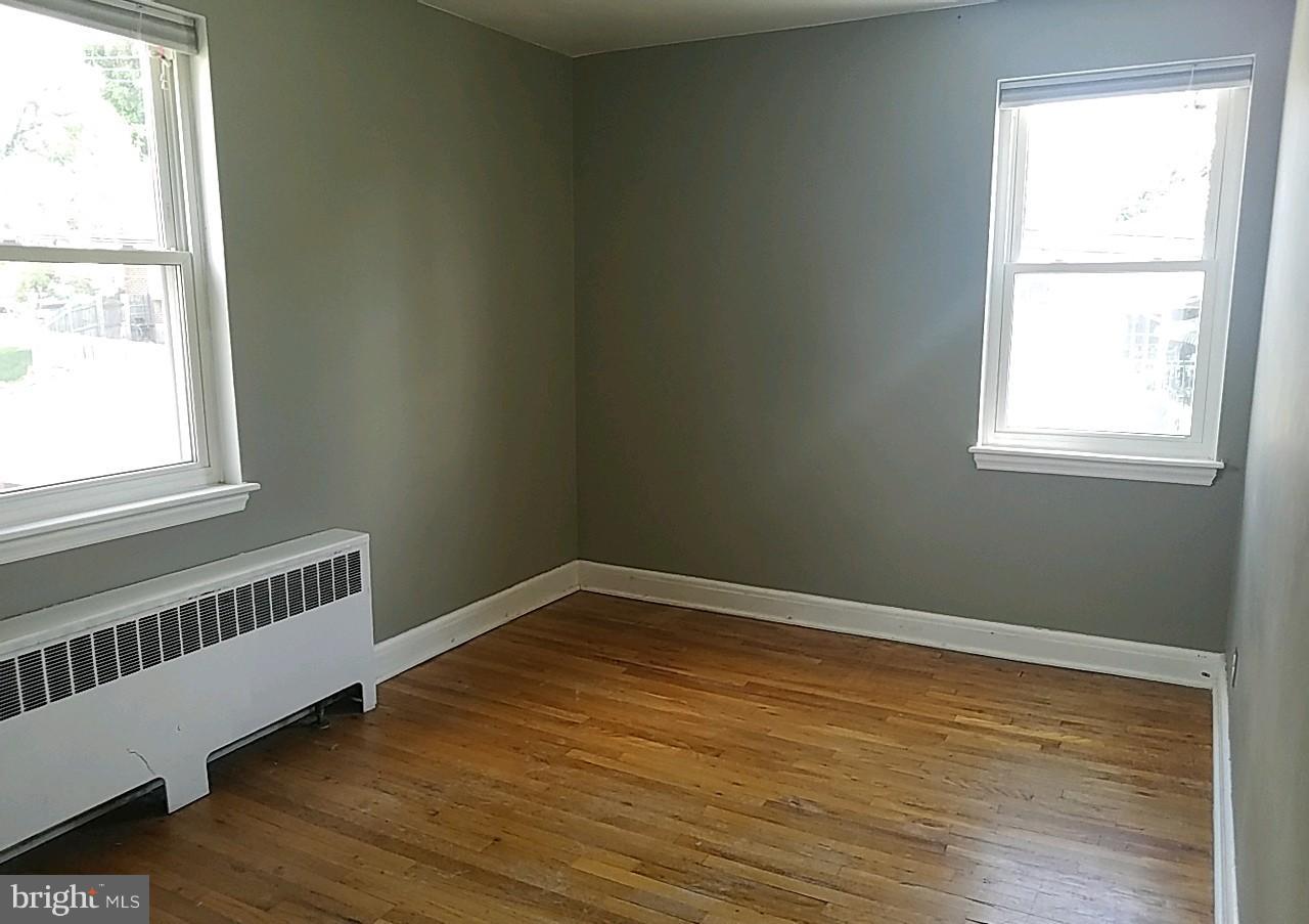 8539 Willow Oak Road Baltimore, MD 21234 - Photo 23 of 30 a view of an empty room with wooden floor and a window