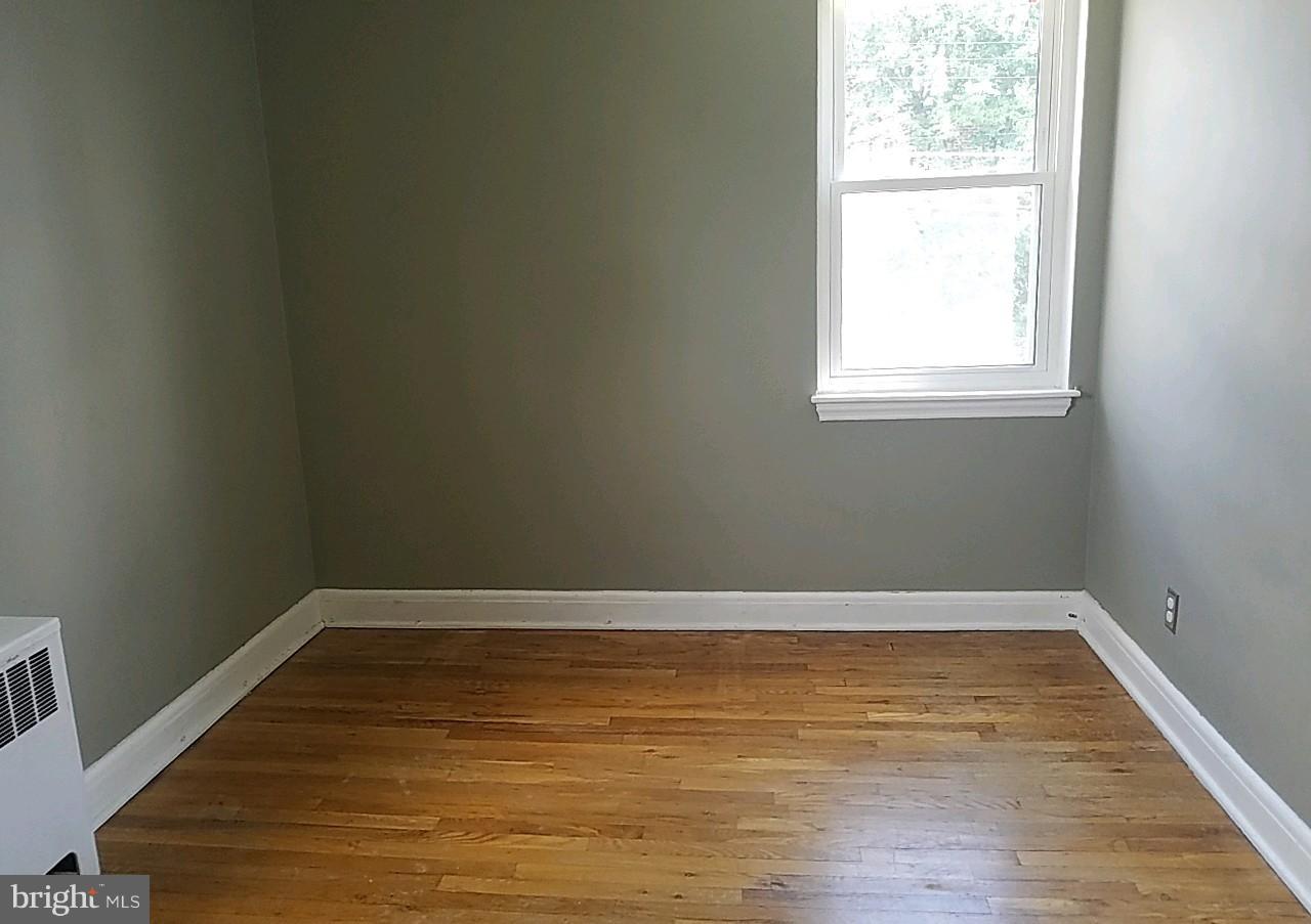 8539 Willow Oak Road Baltimore, MD 21234 - Photo 24 of 30 a view of an empty room with wooden floor and a window
