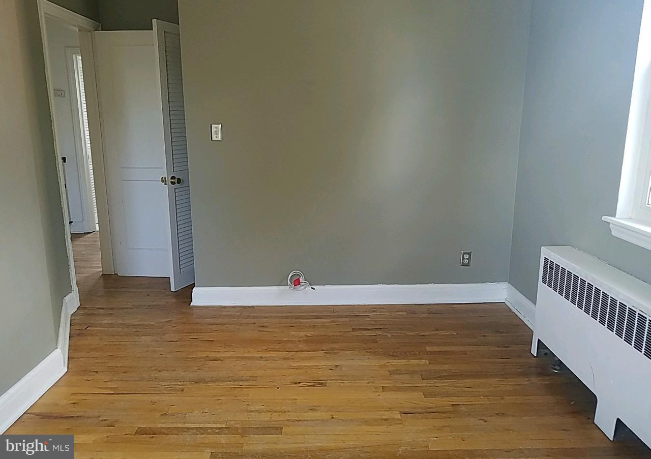 8539 Willow Oak Road Baltimore, MD 21234 - Photo 25 of 30 a view of an empty room with wooden floor and a window