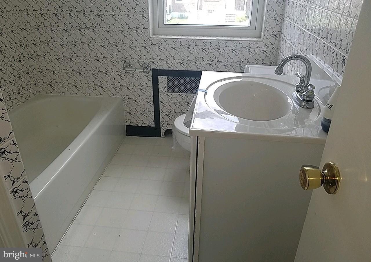 8539 Willow Oak Road Baltimore, MD 21234 - Photo 26 of 30 a bathroom with a sink and a bathtub