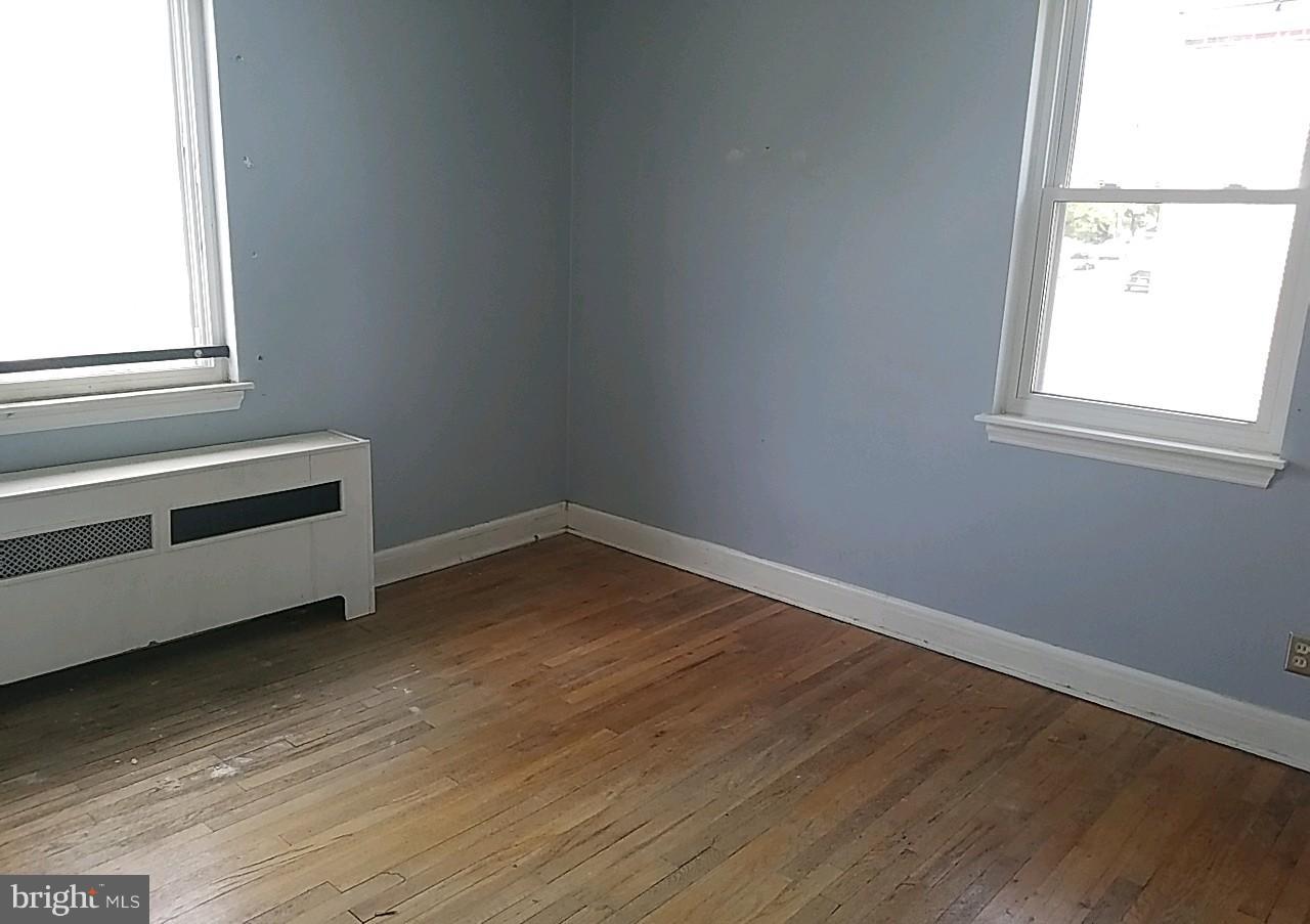 8539 Willow Oak Road Baltimore, MD 21234 - Photo 30 of 30 an empty room with wooden floor and windows