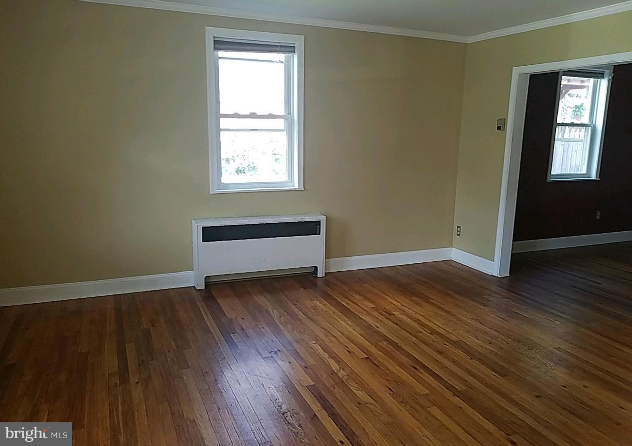 8539 Willow Oak Road Baltimore, MD 21234 - Photo 5 of 30 an empty room with wooden floor and windows