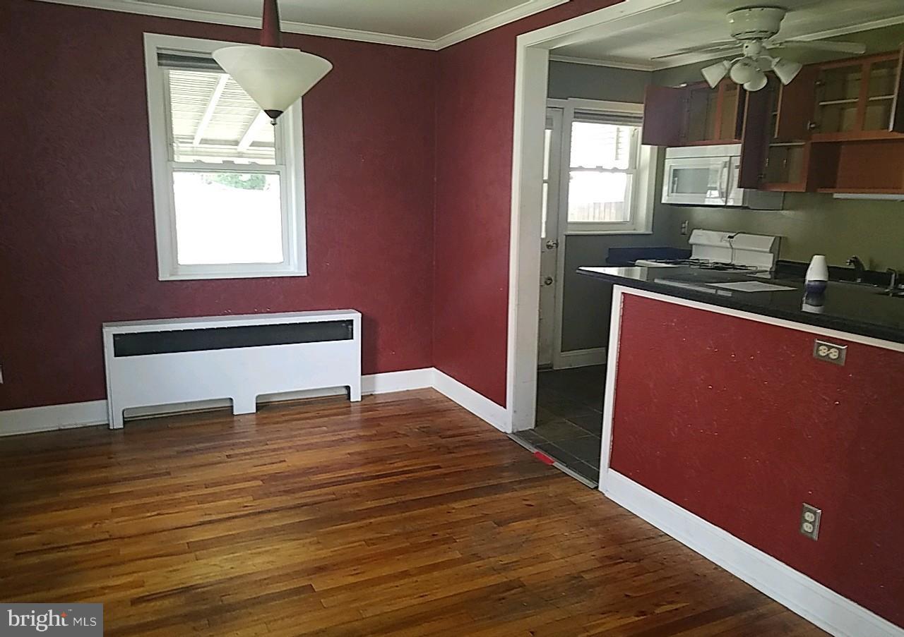 8539 Willow Oak Road Baltimore, MD 21234 - Photo 7 of 30 a view of a kitchen with wooden floor and a window
